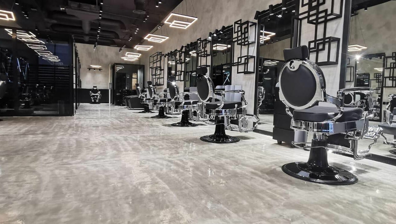 Elegant salon chairs lined up at Handsome Box, Riyadh, SA in a modern, chic setting.