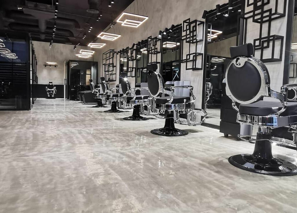 Elegant salon chairs lined up at Handsome Box, Riyadh, SA in a modern, chic setting.