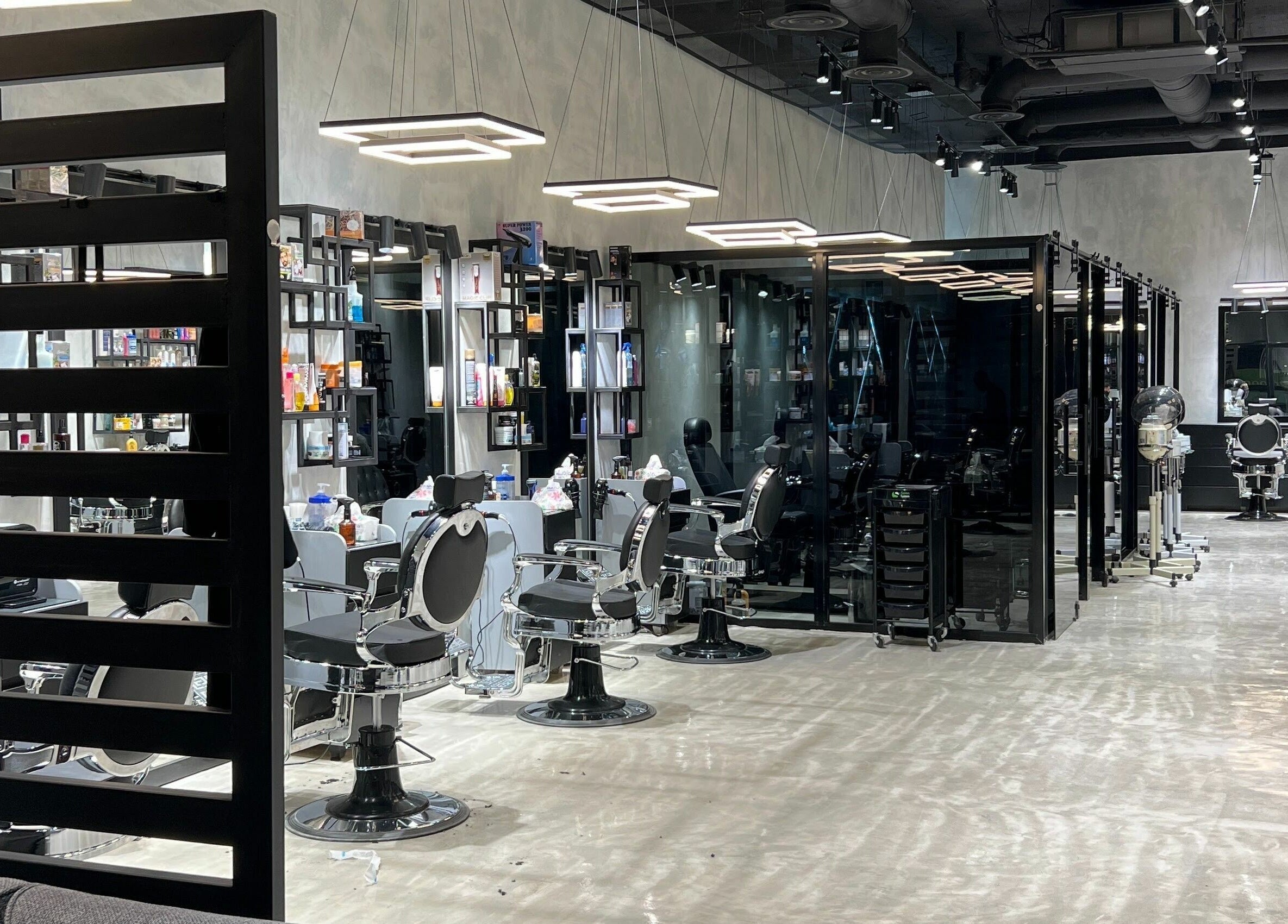 Inside view of the modern Handsome Box salon in Riyadh, SA showcasing sleek, well-lit styling stations.