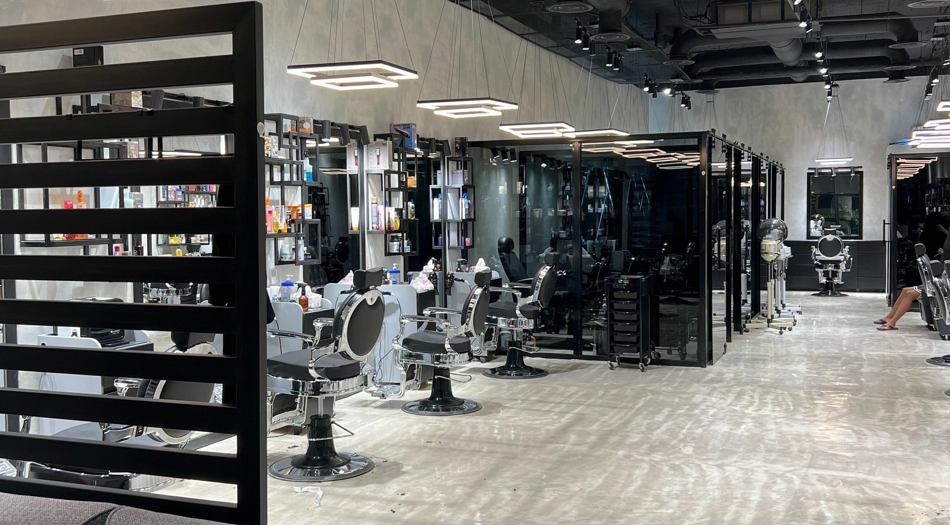 Inside view of the modern Handsome Box salon in Riyadh, SA showcasing sleek, well-lit styling stations.