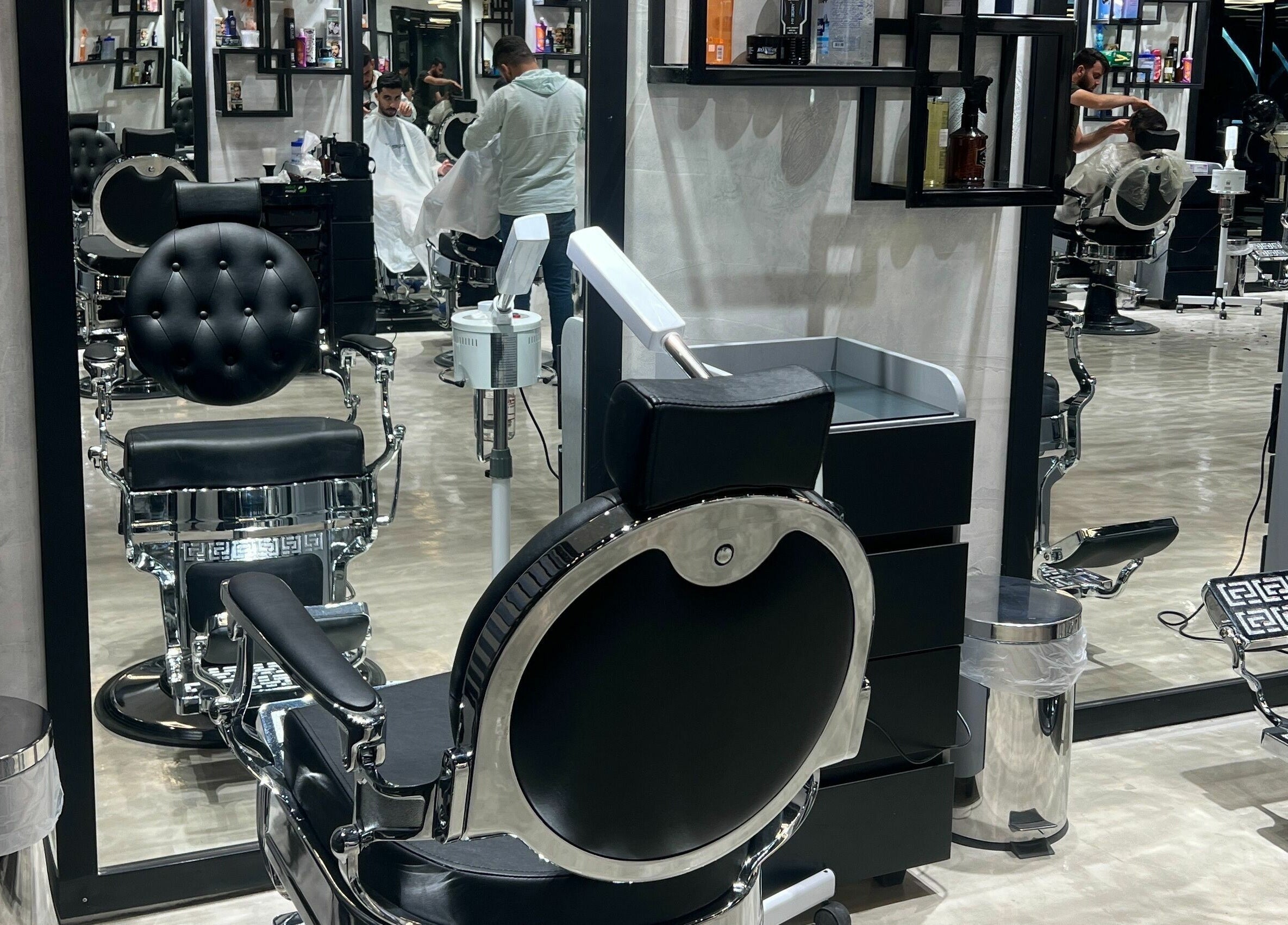 Elegant black salon chairs at Handsome Box, Riyadh, SA, showcasing a modern, inviting atmosphere.