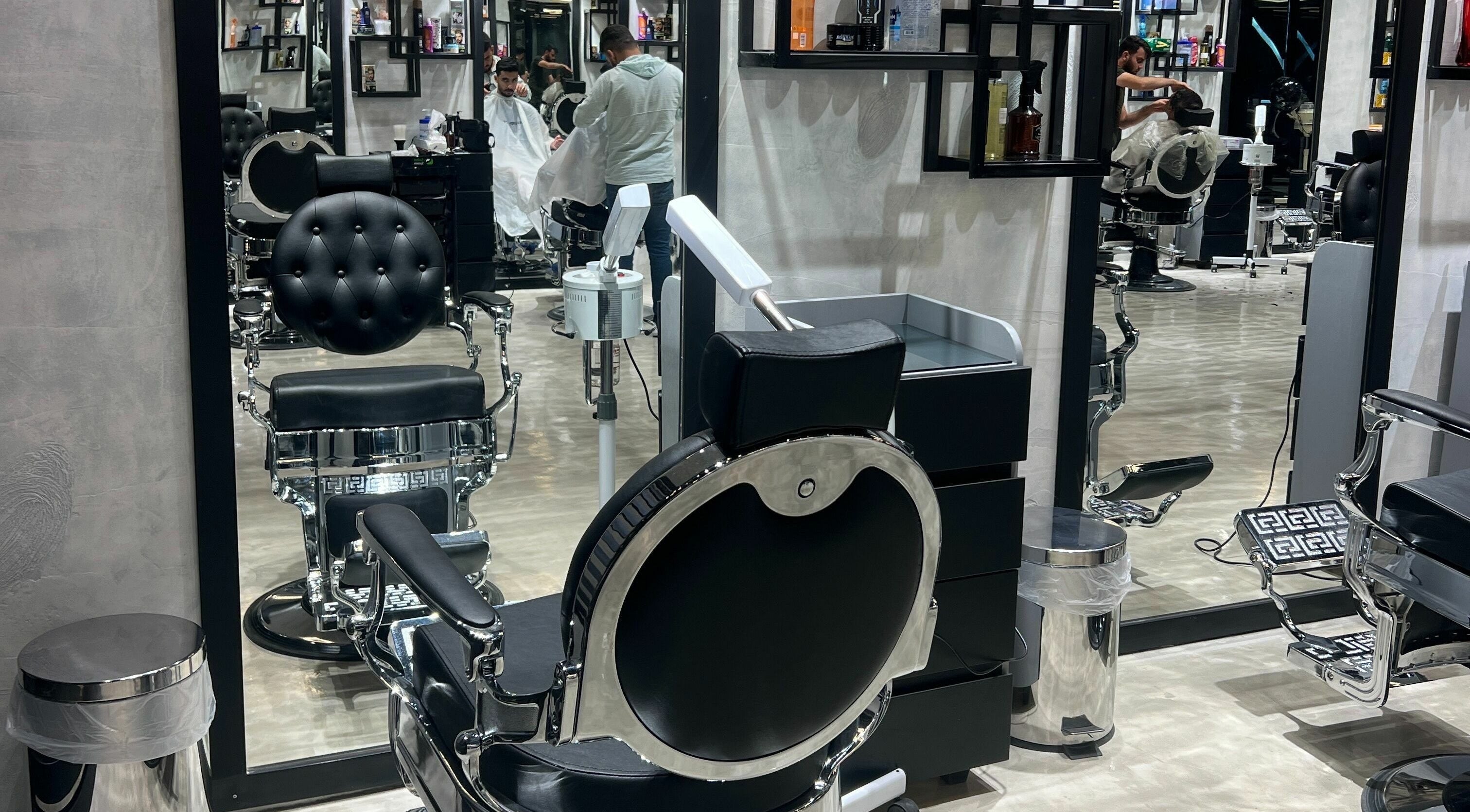 Elegant black salon chairs at Handsome Box, Riyadh, SA, showcasing a modern, inviting atmosphere.