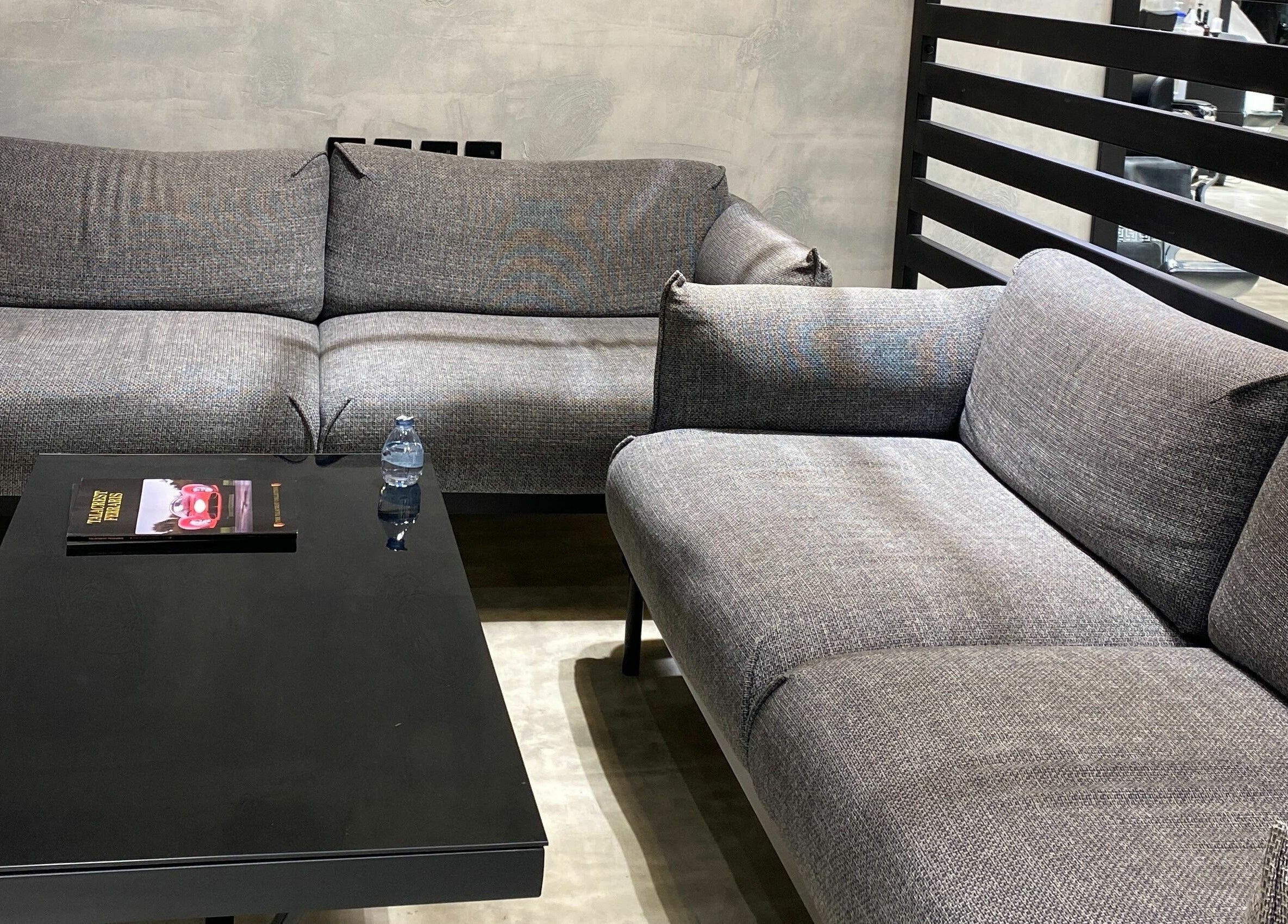 Comfortable lounge area with modern grey sofas at Handsome Box, Riyadh, SA, offering a relaxing atmosphere.