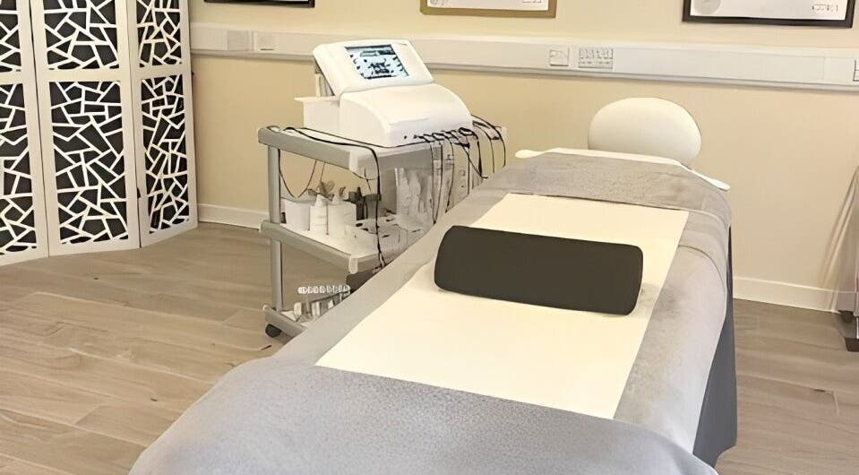 Treatment room at Christol Beauty, Douglas, Isle of Man, GB with massage table and equipment cart.