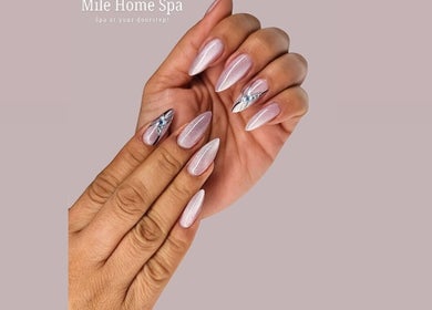 Elegant nail art at Mile Home Spa, Abu Dhabi, AE showcasing shimmering designs and detailed craftsmanship.