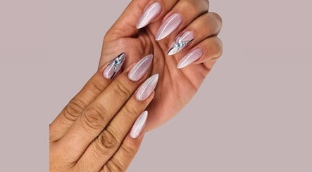 Stylish nail art design at Mile Home Spa in Abu Dhabi, Abu Dhabi, AE showcasing elegant, shimmering nail decorations.
