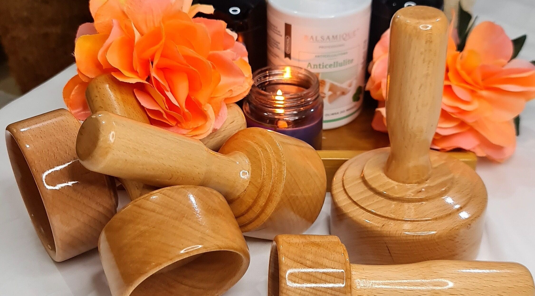 Wooden spa tools and vibrant flowers at Mile Home Spa create a serene ambience in Abu Dhabi, Abu Dhabi, AE.