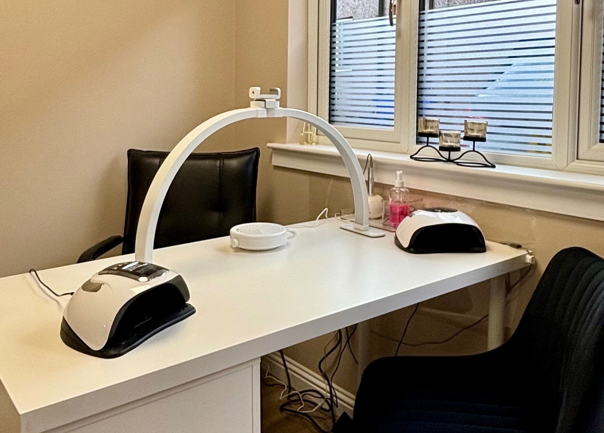 Cozy nail station at Elements of Beauty, Fallin, Scotland, GB, with modern equipment and seating.