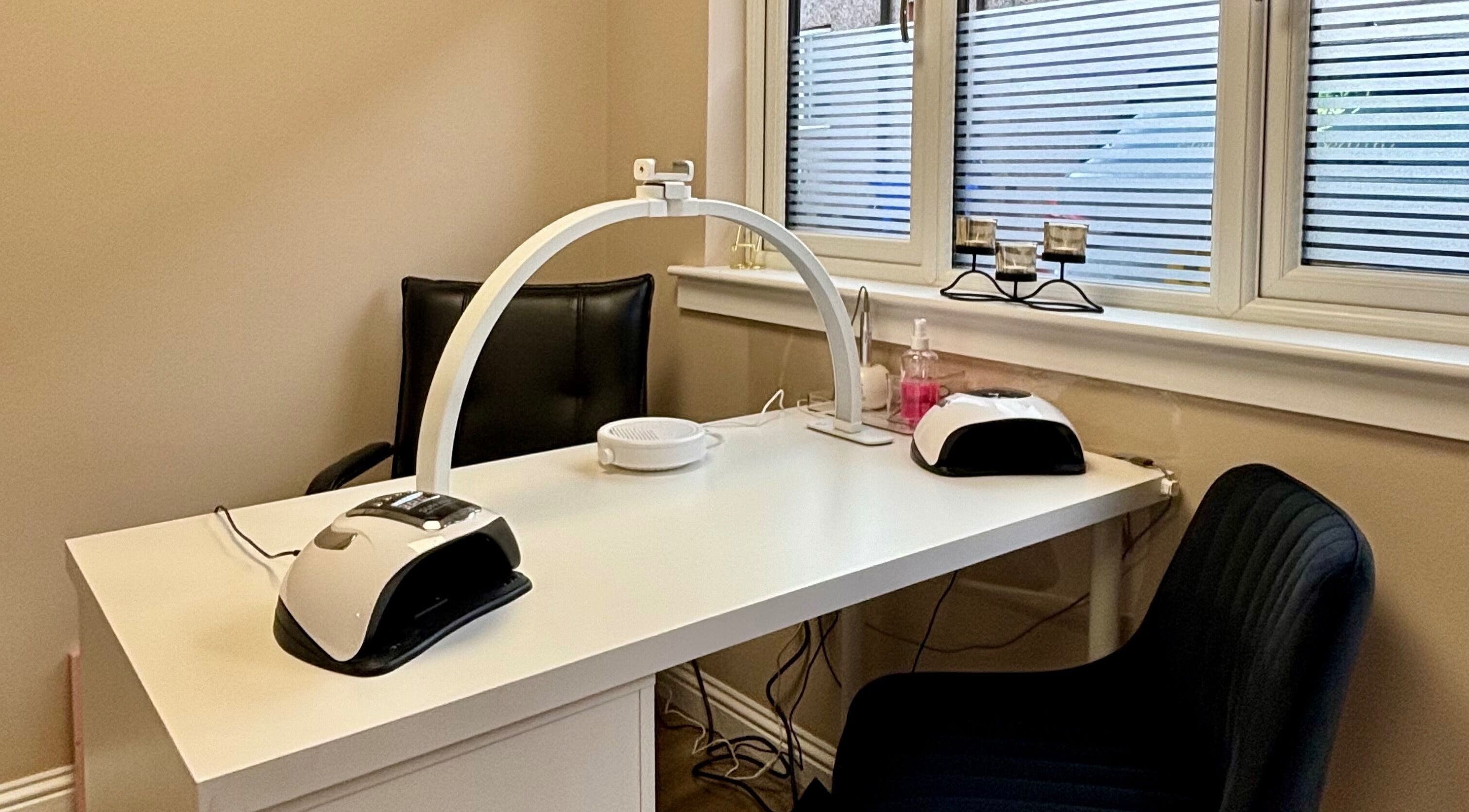 Cozy nail station at Elements of Beauty, Fallin, Scotland, GB, with modern equipment and seating.