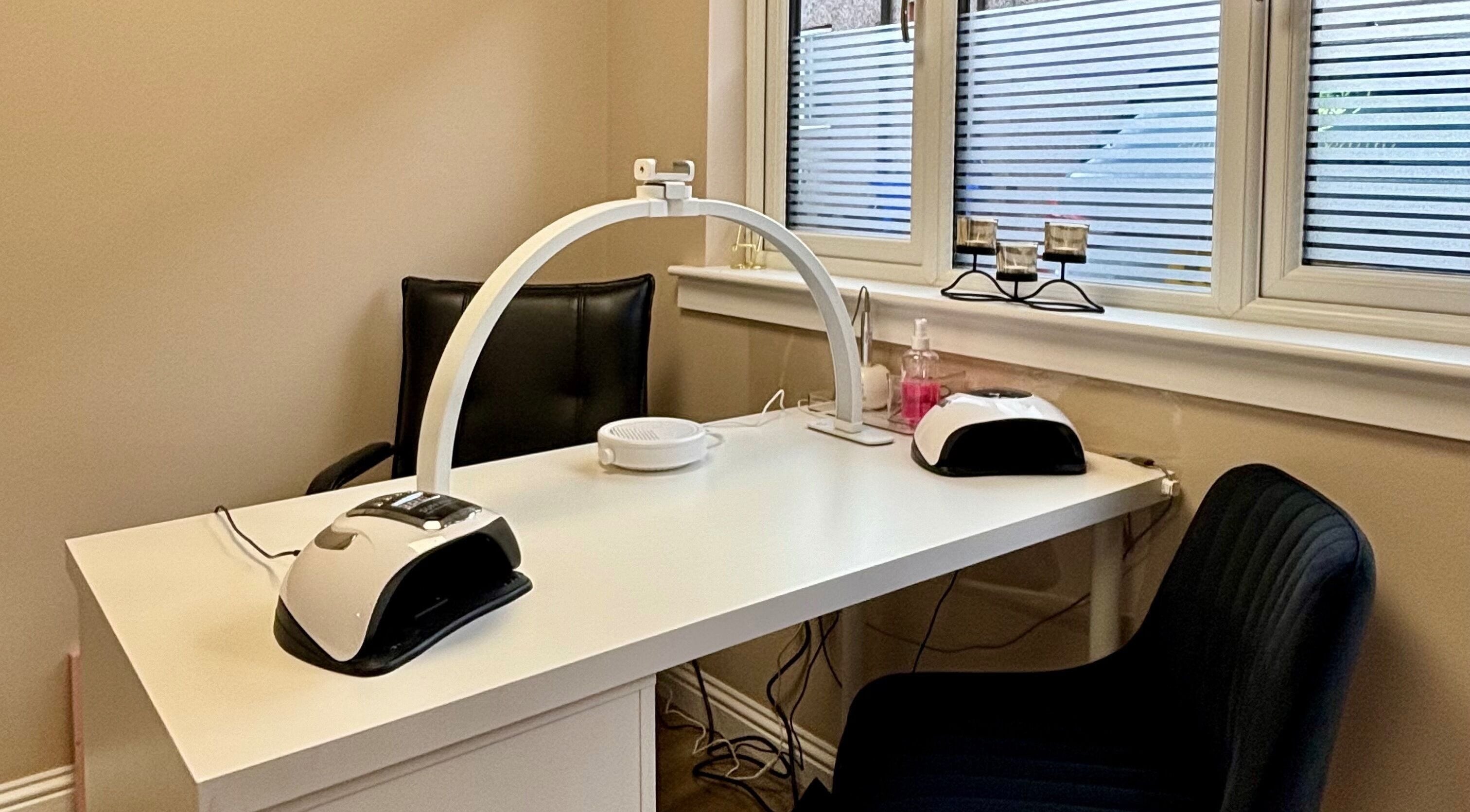 Cozy nail station at Elements of Beauty, Fallin, Scotland, GB, with modern equipment and seating.