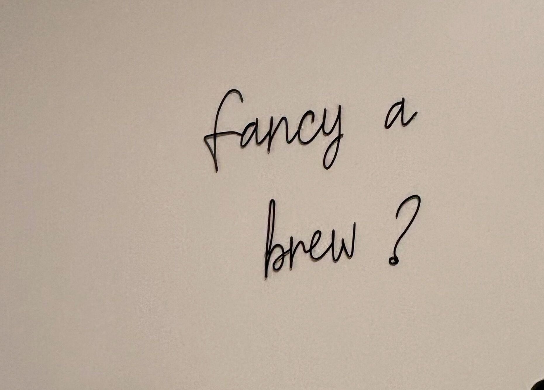 Decorative wall text 'Fancy a brew?' at Elements of Beauty, Fallin, Scotland, GB.