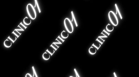 Bright neon text 'Clinic 01' on black background, located in East Kilbride, Scotland, GB.