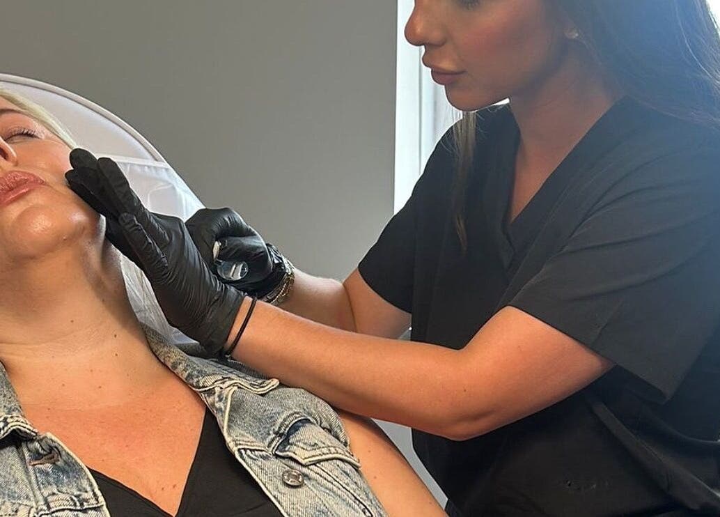 Aesthetic professional treating client at Clinic 01, East Kilbride, Scotland, GB.