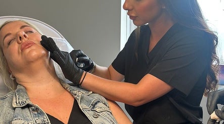 Aesthetic professional treating client at Clinic 01, East Kilbride, Scotland, GB.
