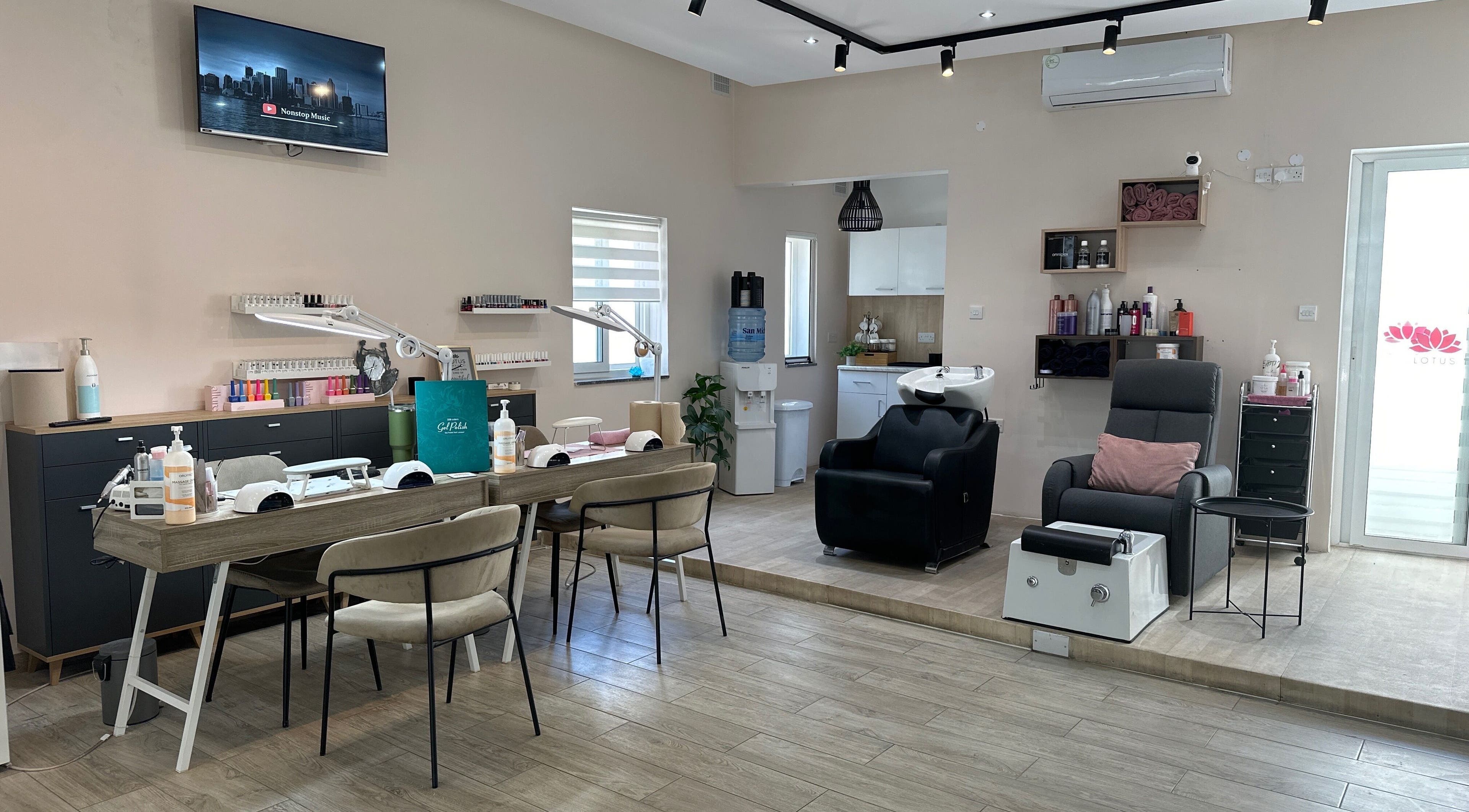 Interior of Lotus Hair and Nail Salon in Il-mellieħa, MT, featuring stylish nail stations and modern decor.