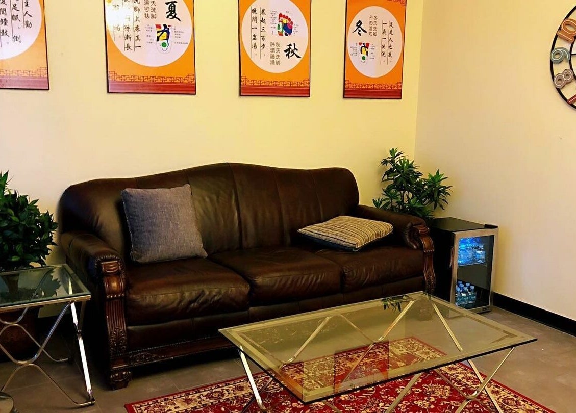 Relaxing lounge area at Z & X Foot Spa in Lutz, Florida, US with plush sofa and soothing decor.