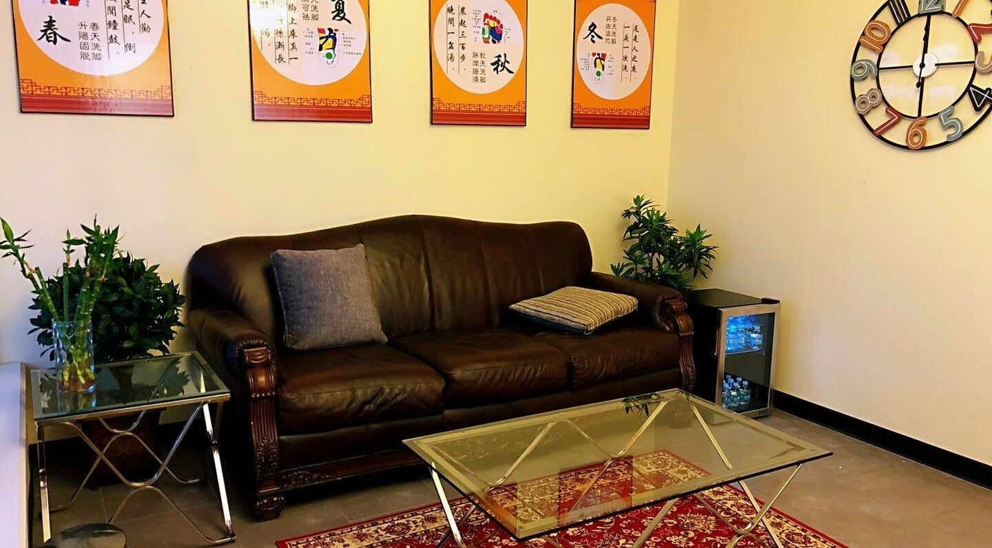 Relaxing lounge area at Z & X Foot Spa in Lutz, Florida, US with plush sofa and soothing decor.