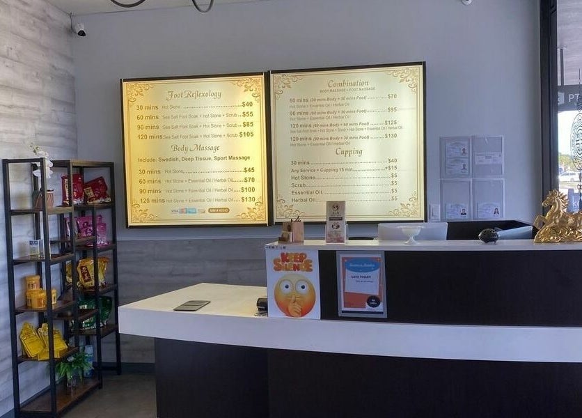 Reception area at Z & X Foot Spa, Lutz, Florida, US showcasing services menu and decor.