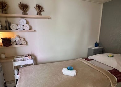 Relaxing massage room at Lanna Thai Massage & Waxing, Cardiff, Wales, GB with warm decor and soft lighting.