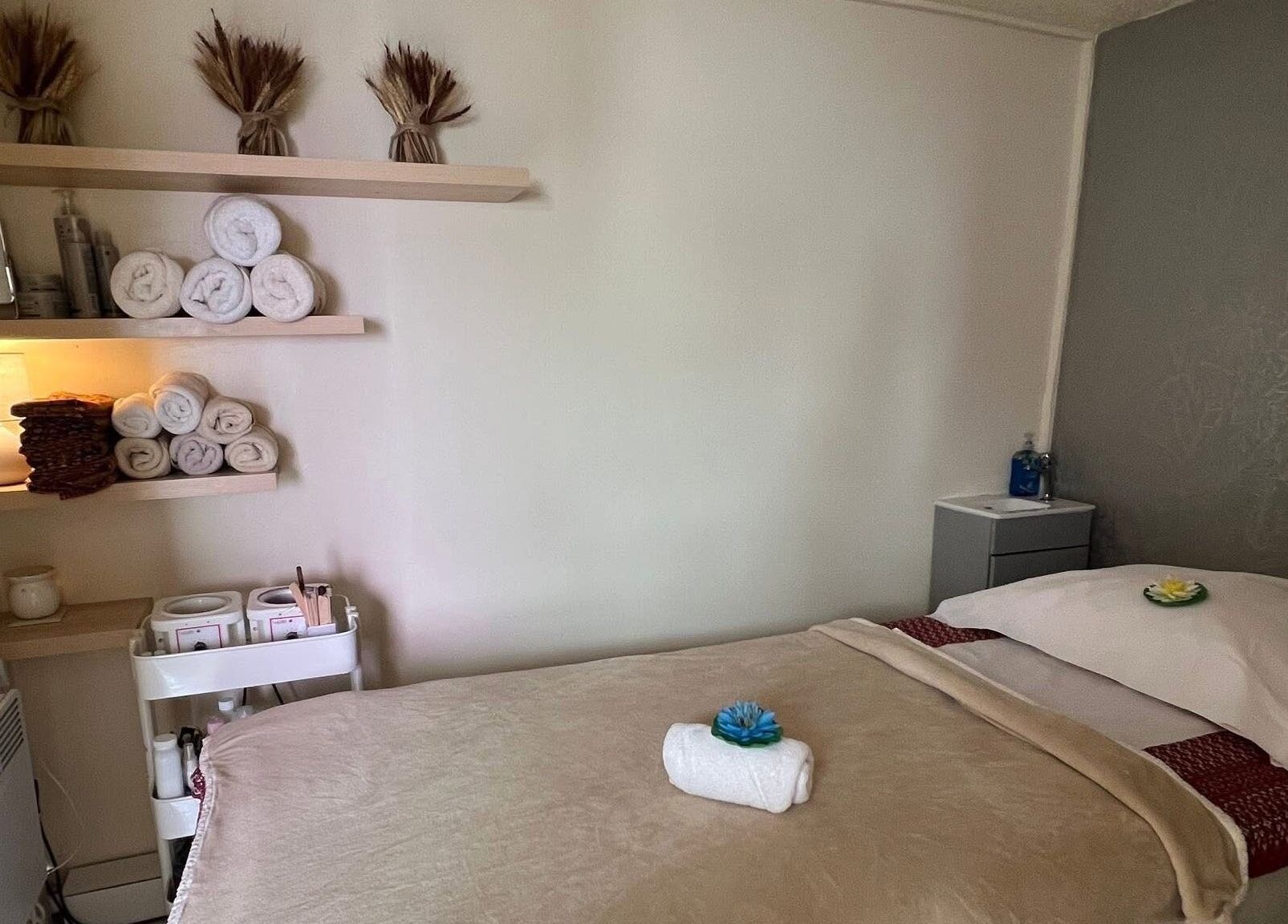 Relaxing massage room at Lanna Thai Massage & Waxing, Cardiff, Wales, GB with warm decor and soft lighting.