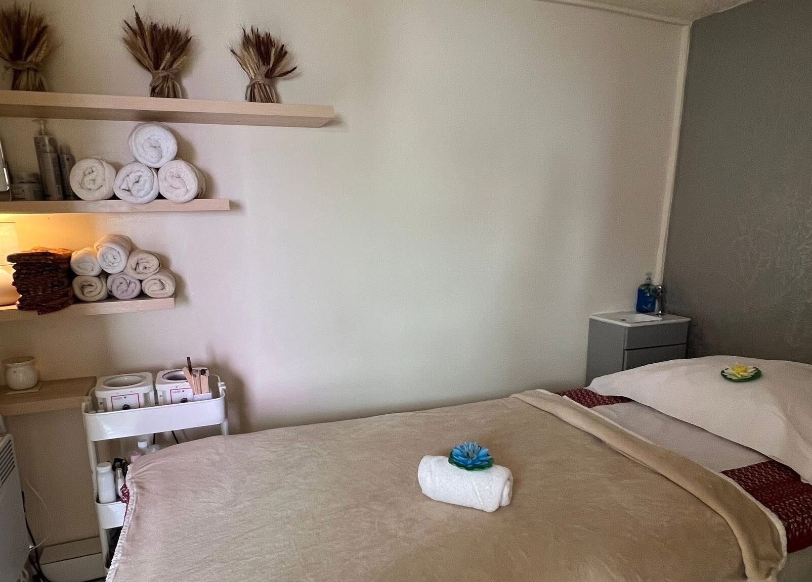 Relaxing massage room at Lanna Thai Massage & Waxing, Cardiff, Wales, GB with warm decor and soft lighting.