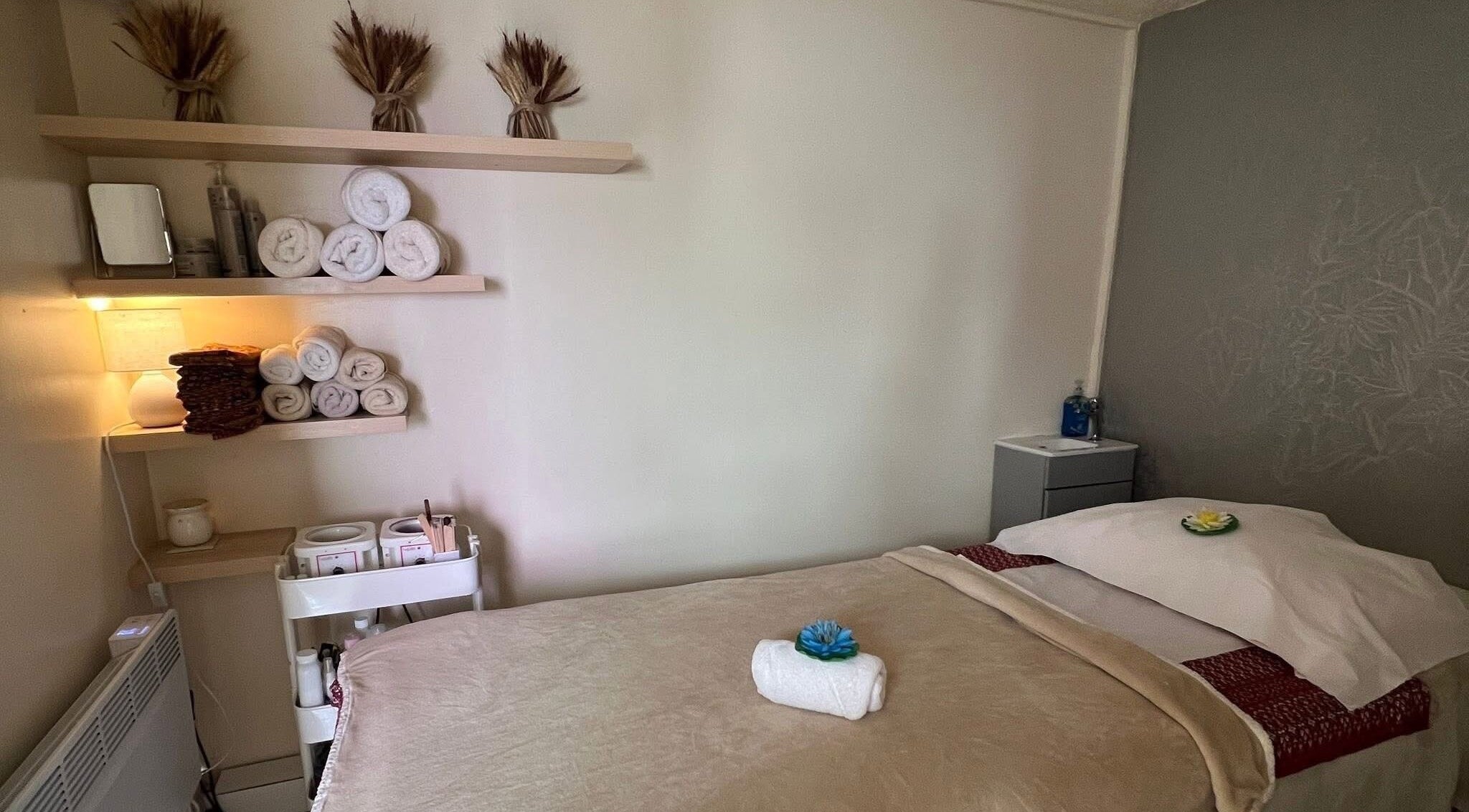 Relaxing massage room at Lanna Thai Massage & Waxing, Cardiff, Wales, GB with warm decor and soft lighting.