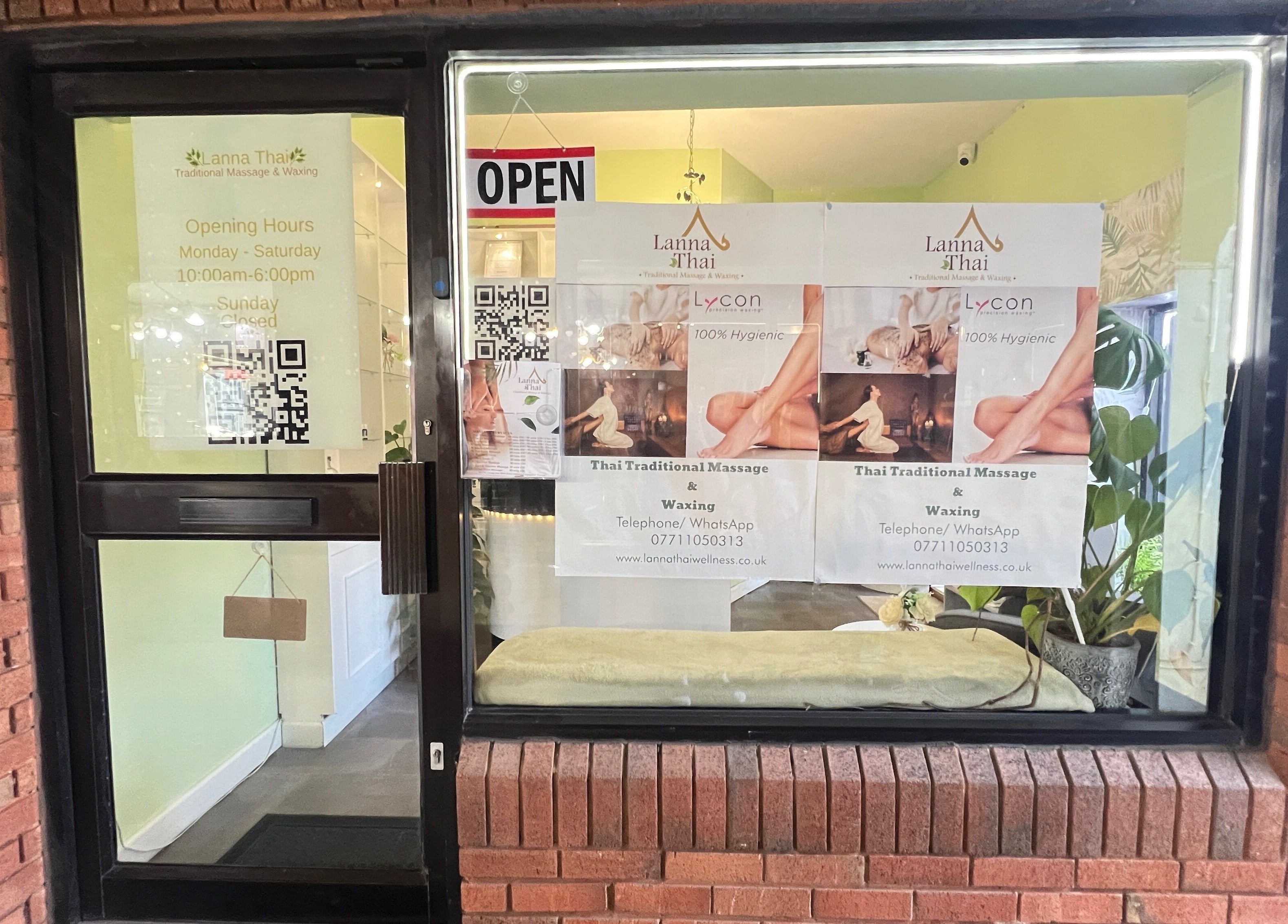 Entrance of Lanna Thai Massage & Waxing in Cardiff, Wales, GB showing open sign and massage posters.
