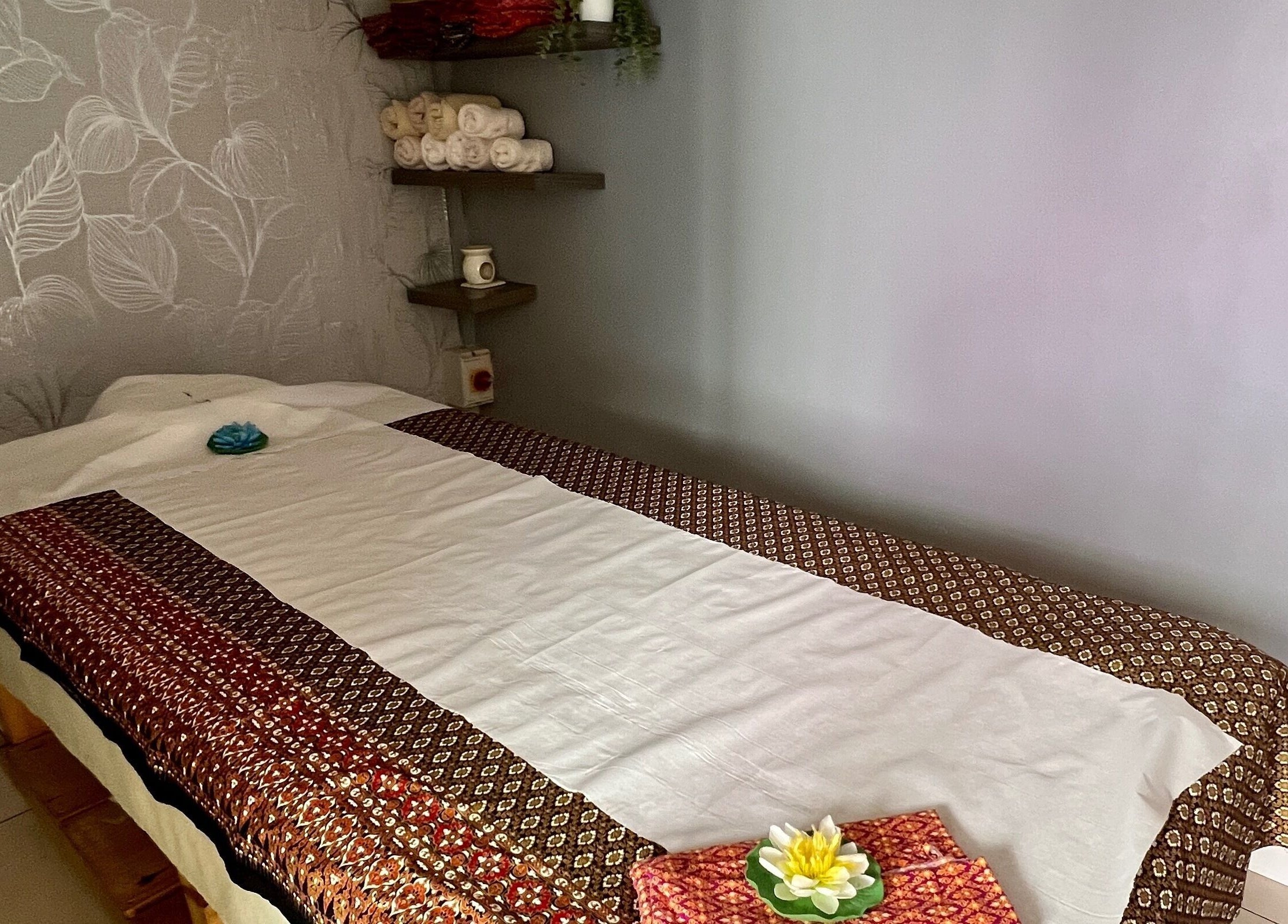 Serene massage room at Lanna Thai Massage & Waxing, Cardiff, Wales, GB with an elegant treatment bed.