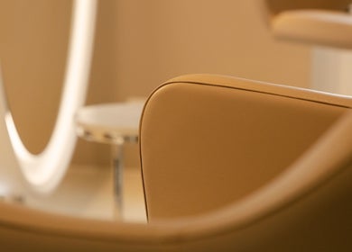 Cozy salon chair with soft lighting at BLONDE.LAB by Caroline Rohwer — Zug, Zug, CH enhancing relaxation.