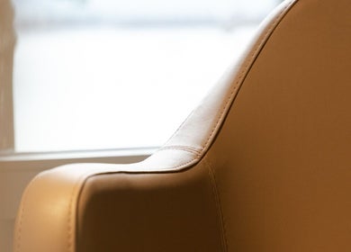 Elegant leather chair at BLONDE.LAB by Caroline Rohwer — Zug, providing comfort in Zug, Zug, CH.