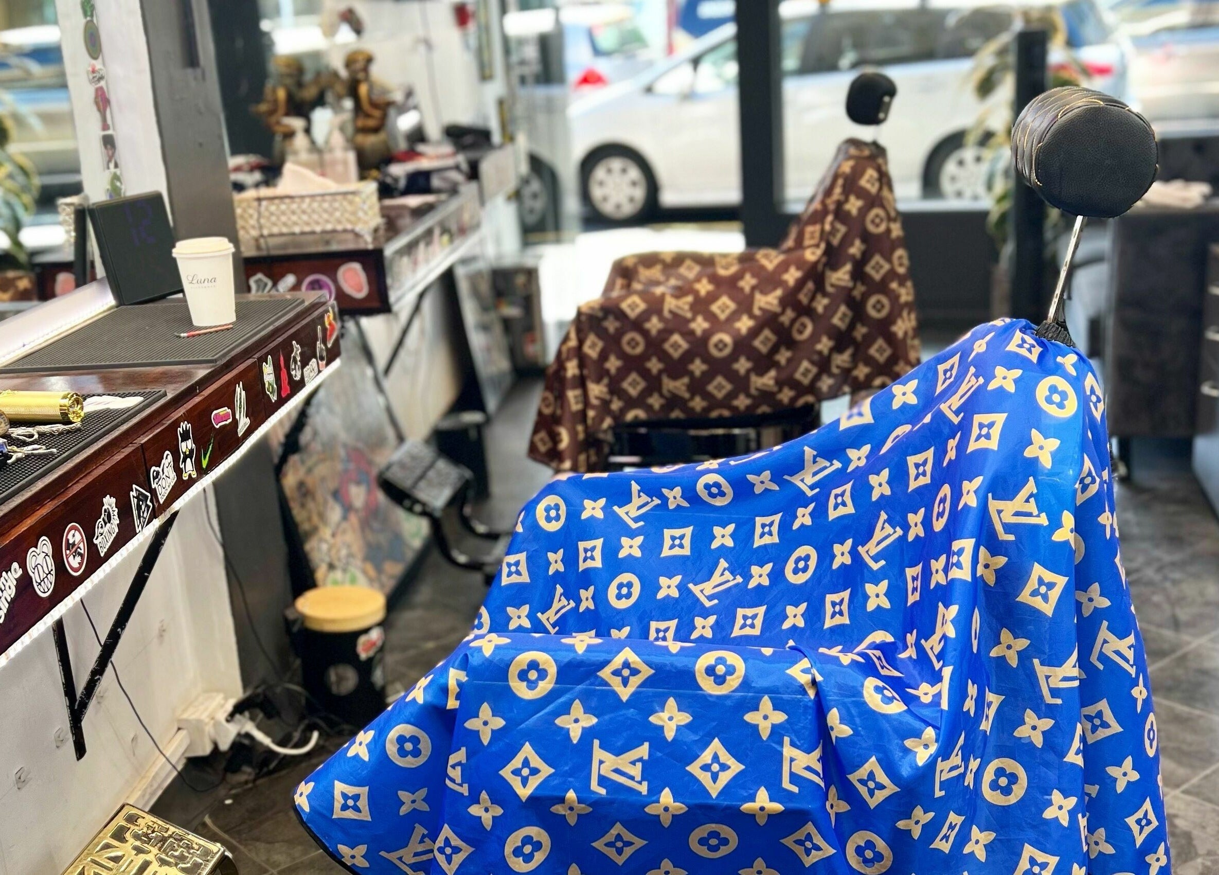 Barbershop chairs at Studio Image Barbershop, Auckland, NZ with designer capes in vibrant colors.