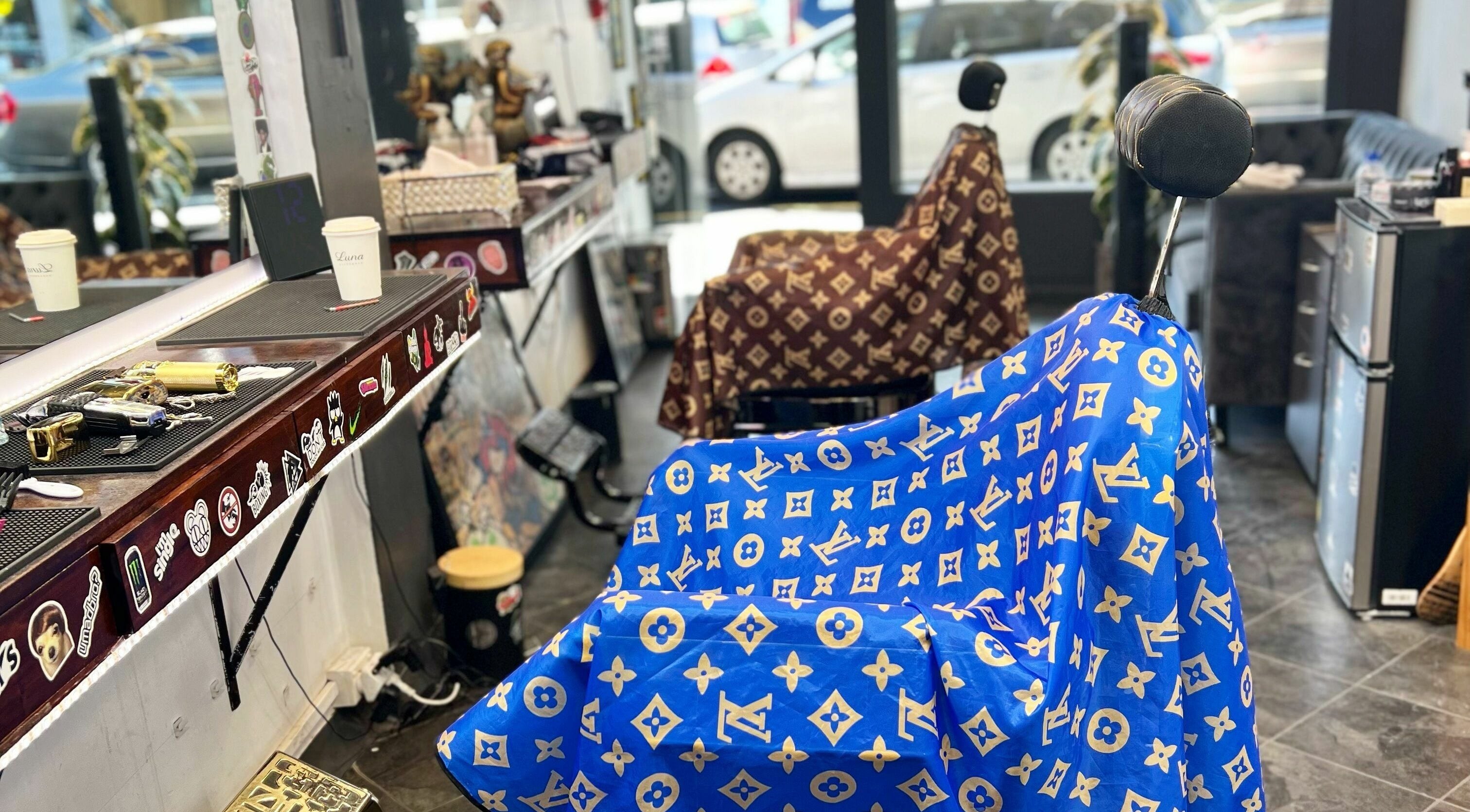 Barbershop chairs at Studio Image Barbershop, Auckland, NZ with designer capes in vibrant colors.