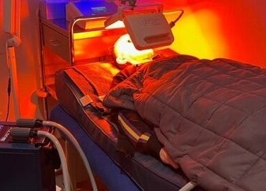A person relaxes under a red light therapy at Biohacking Melbourne in Melbourne, Victoria, AU.