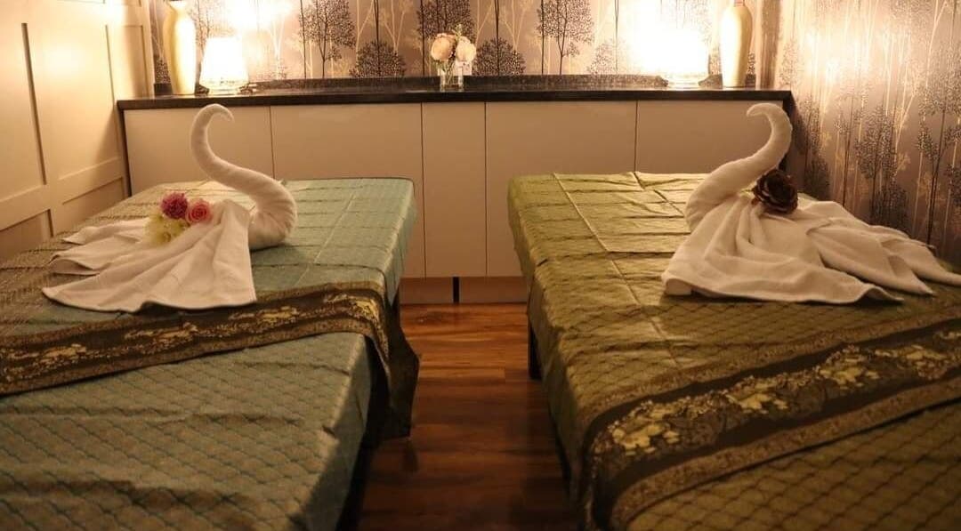 Tranquil treatment room at Baan Thai Wellness And Spa, Huntingdon, England, GB, with elegant decor and swan towels.