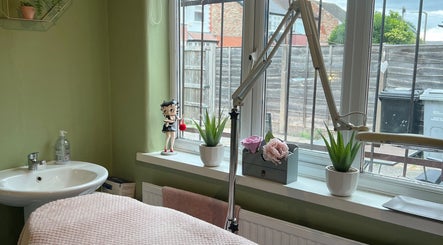 Relaxing interior of 1 Love Enhancink @Studio55 in Urmston, England, GB with window plants and a cozy bed.