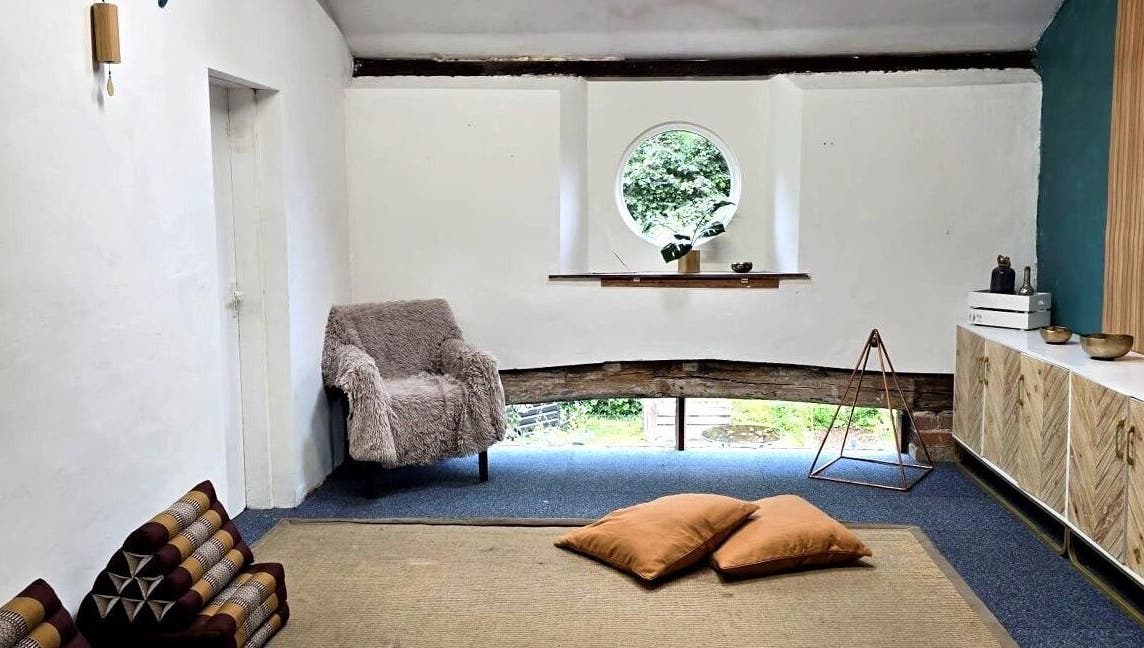 Inviting relaxation space in The Unity Room, Carrington, England, GB with cushions and natural light.