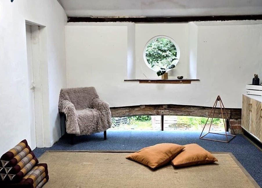 Inviting relaxation space in The Unity Room, Carrington, England, GB with cushions and natural light.