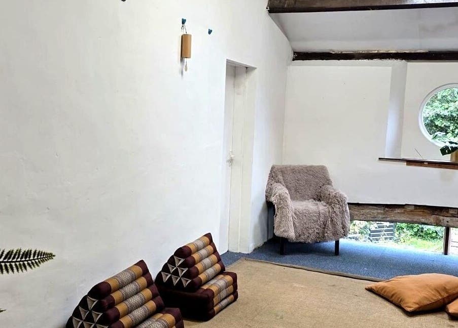 The Unity Room's tranquil reading nook with plush seating in Carrington, England, GB, offering a serene escape.