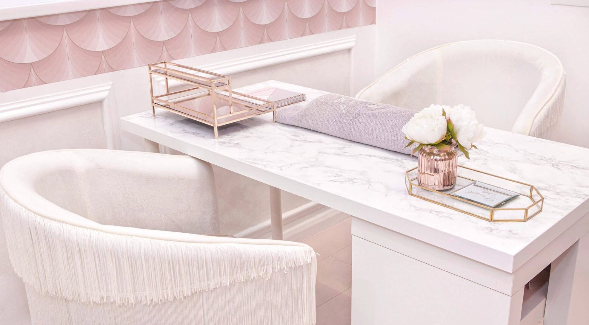 Elegant salon desk interior at Empire of Hair, Stoke-on-Trent, England, GB with white chairs and decor.