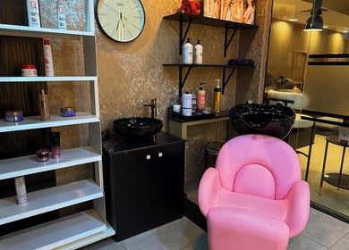 Modern salon corner at M and N Nail Spa, Dubai, AE, featuring pink chair and product display.