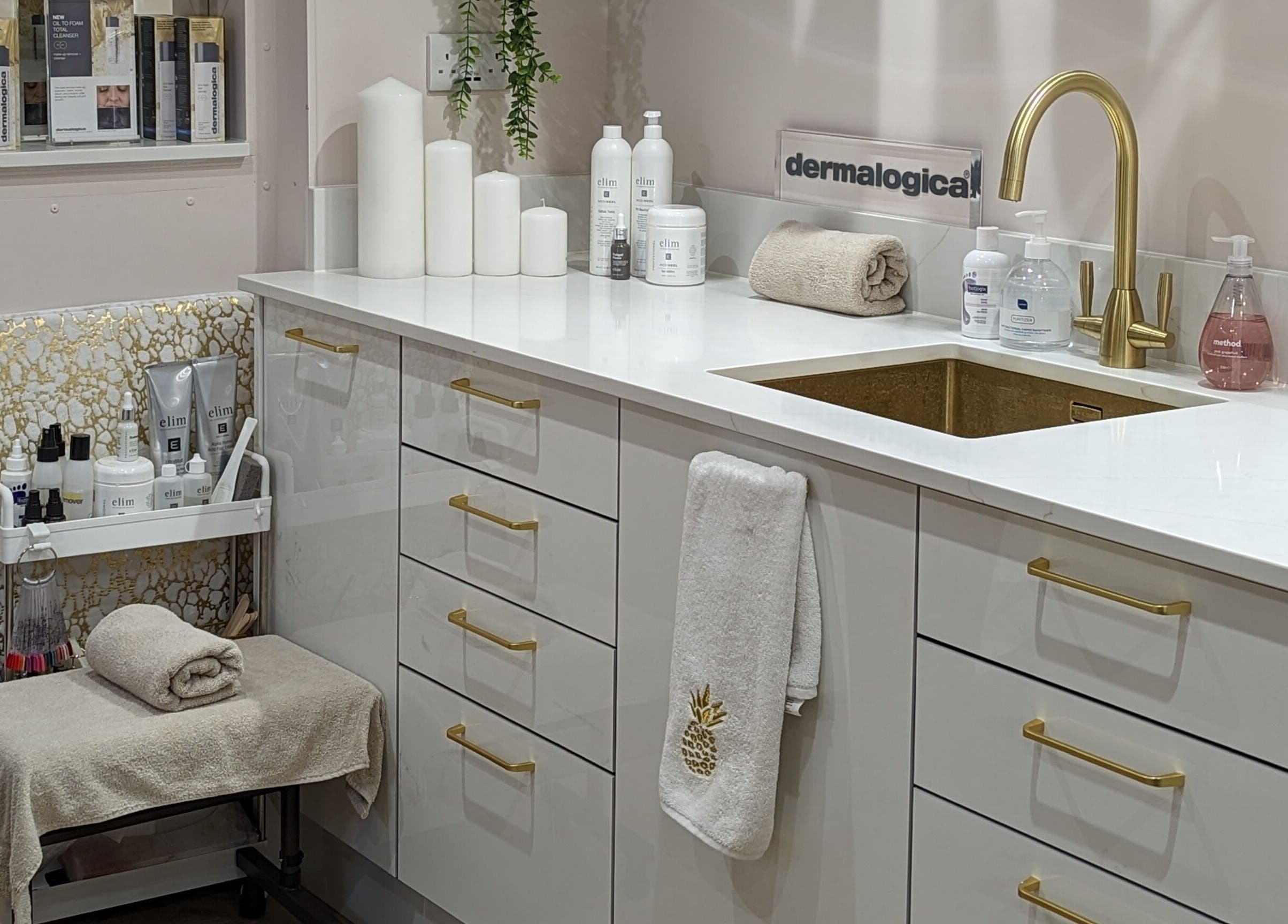 Modern beauty treatment area at GBM Beauty Aesthetics in Ruislip, England with elegant white cabinetry.