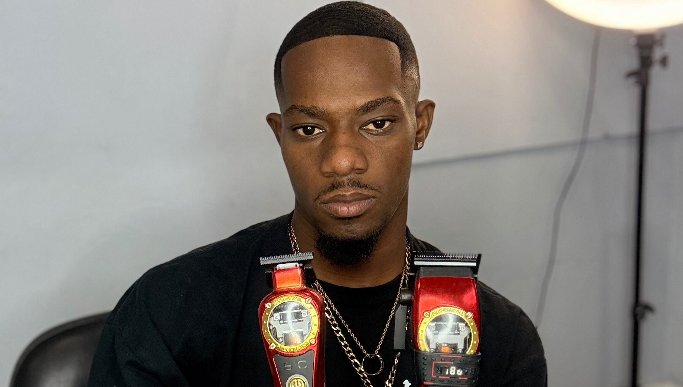 Barber with clippers at CliffCutz, St.patricks, Christ Church, BB, showcasing top-notch grooming tools.