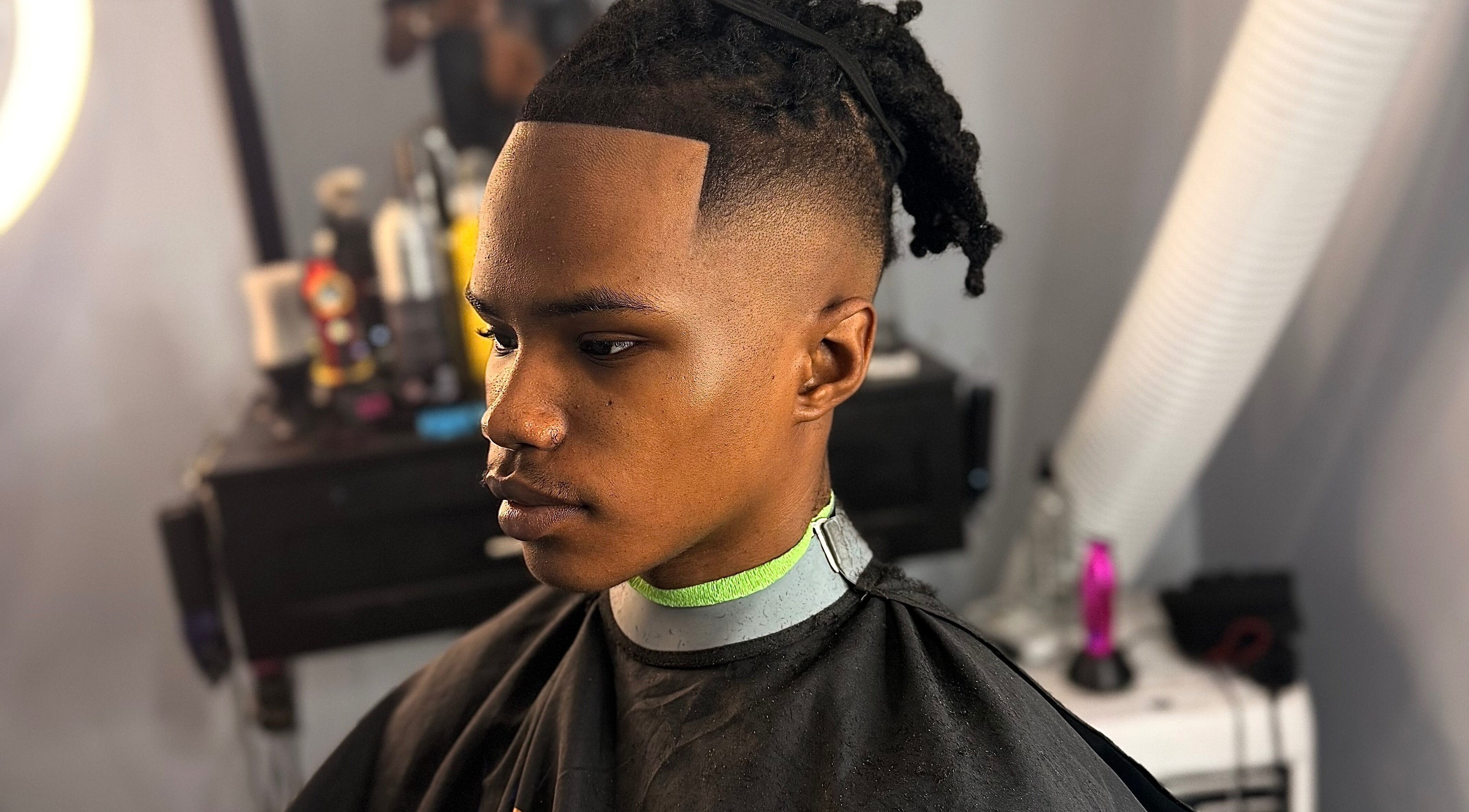 Man showcasing a fresh fade hairstyle at CliffCutz, St.patricks, Christ Church, BB.