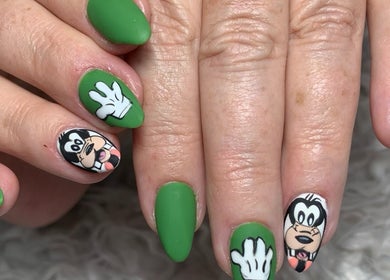 Cartoon-themed green nails at Dezz Nails and Glam Studio, Johannesburg, Gauteng, ZA showcasing unique design.