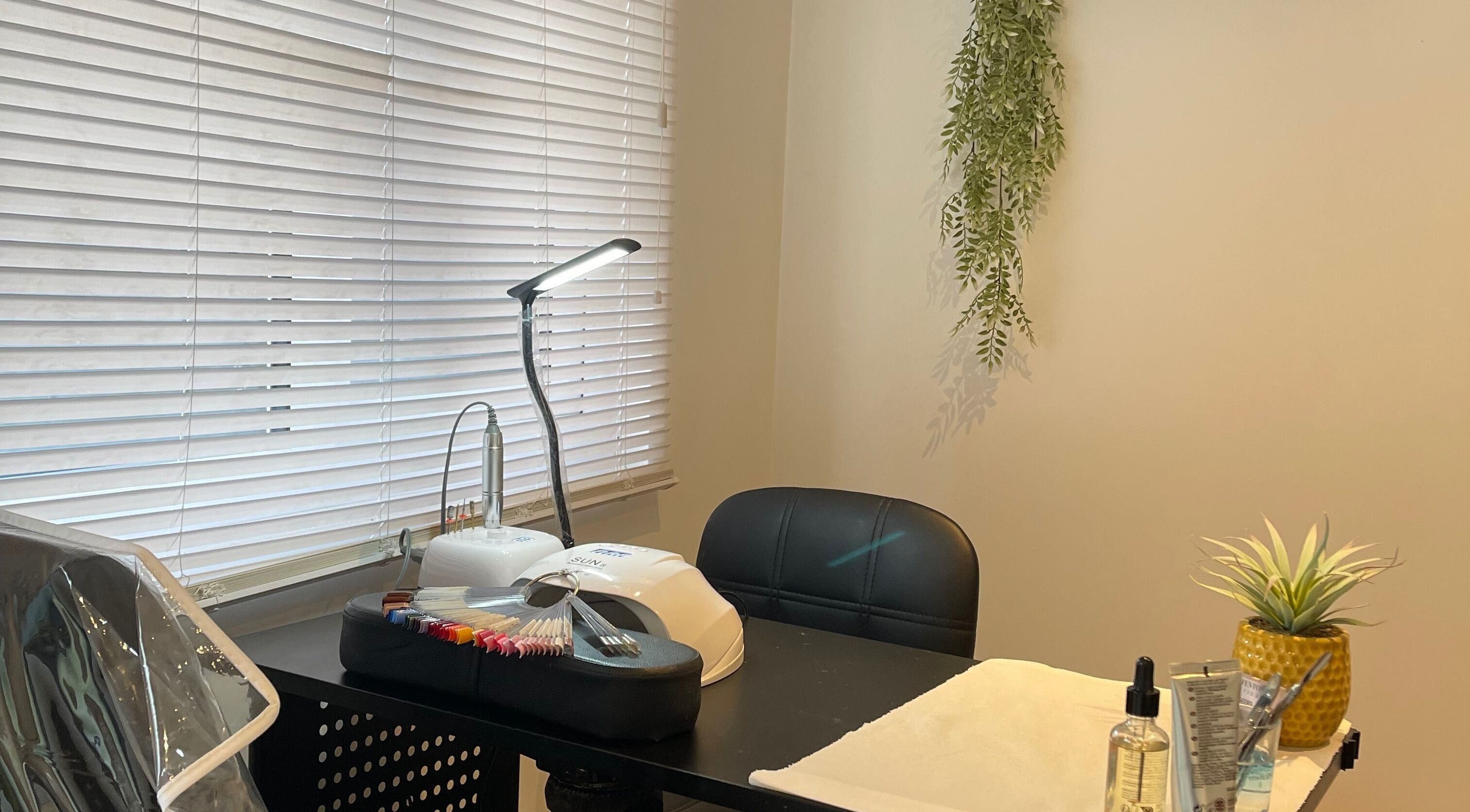 Cozy nail treatment station at Taylor Fenton Cosmetics, Whitstable, England, GB, with ambient lighting and decor.