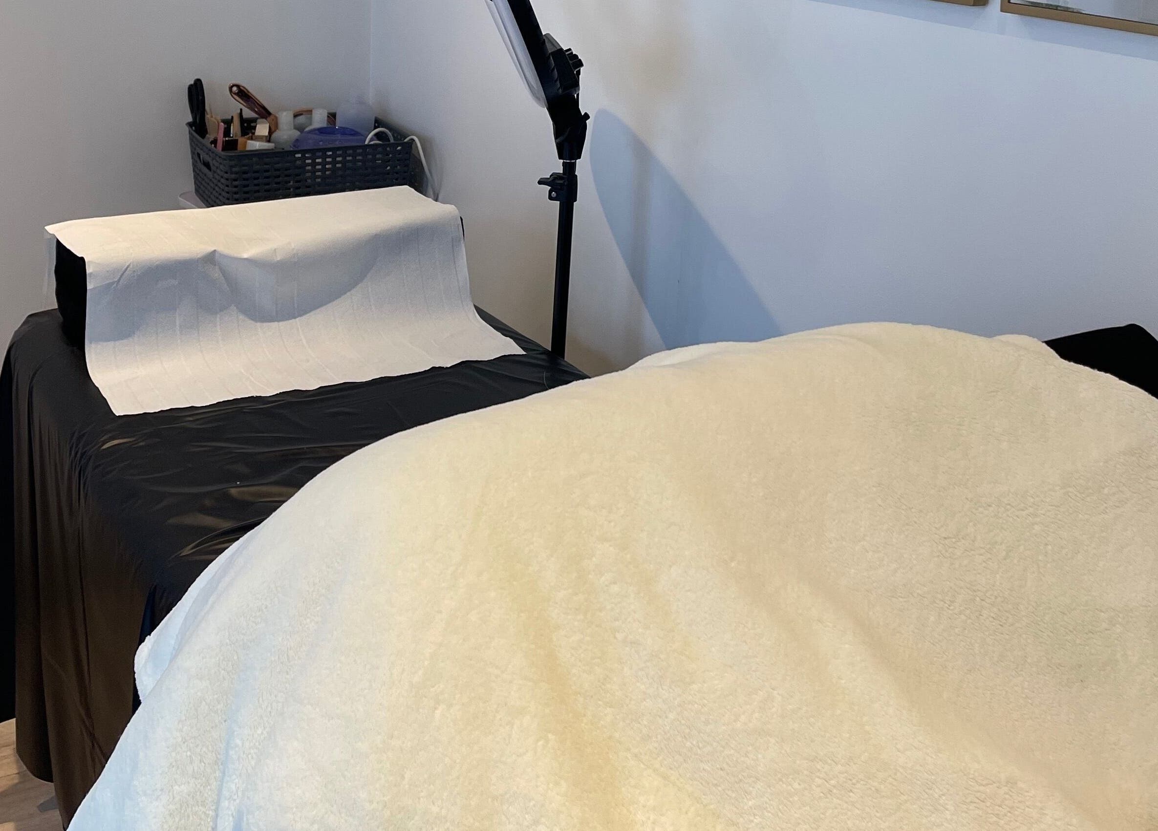 Cozy treatment room at Taylor Fenton Cosmetics, Whitstable, England, GB, with a plush bed and modern decor.