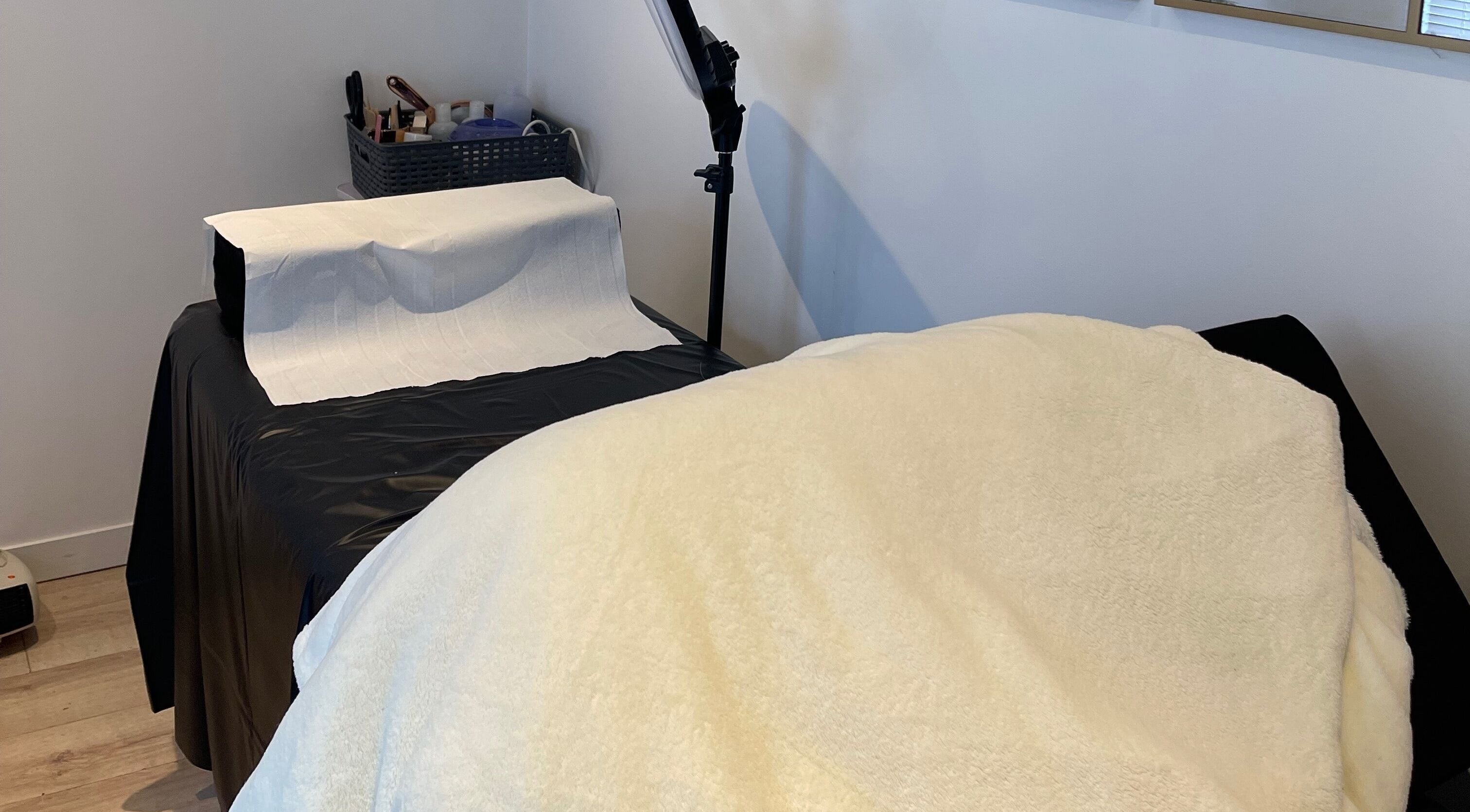 Cozy treatment room at Taylor Fenton Cosmetics, Whitstable, England, GB, with a plush bed and modern decor.