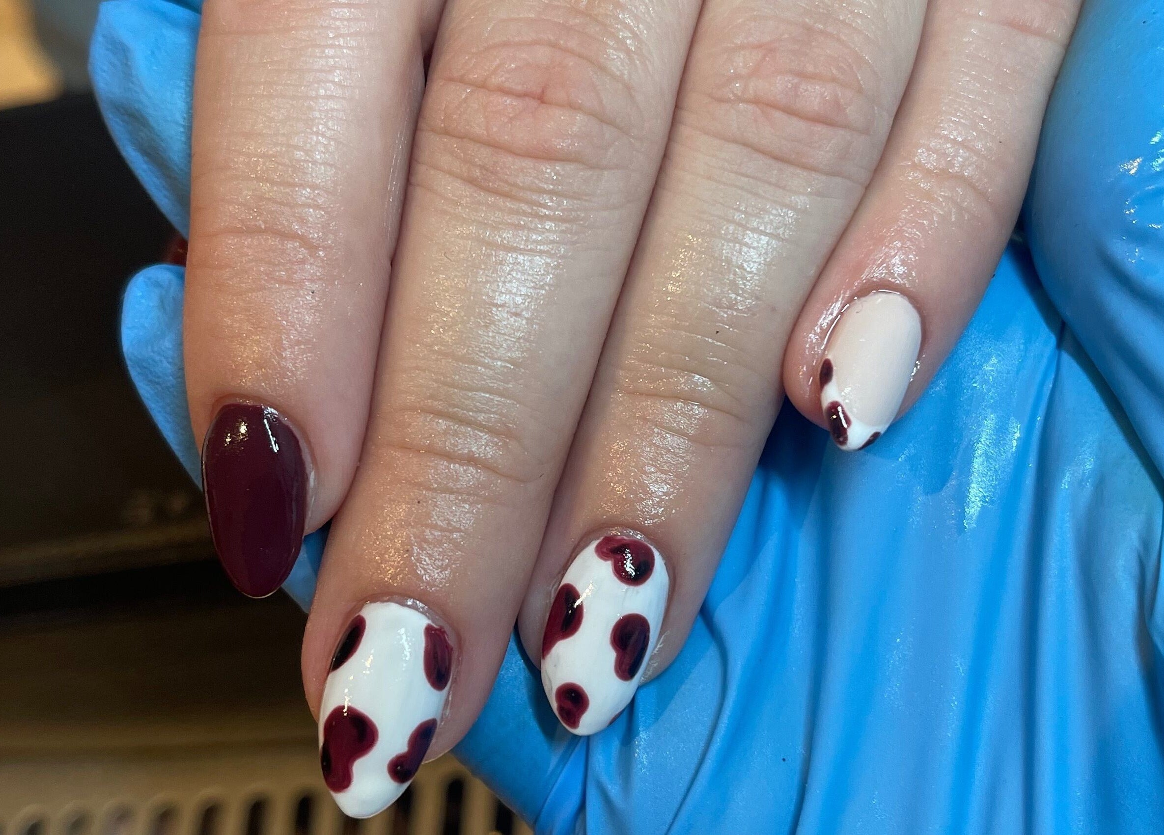Elegant nail art with burgundy and white design at Taylor Fenton Cosmetics, Whitstable, England, GB.