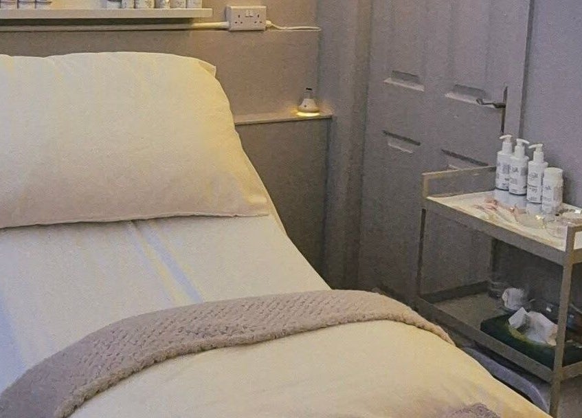 Cozy treatment bed at Nirvana Beauty & Massage, Bonnybridge, Scotland, GB, highlighting soothing comfort.