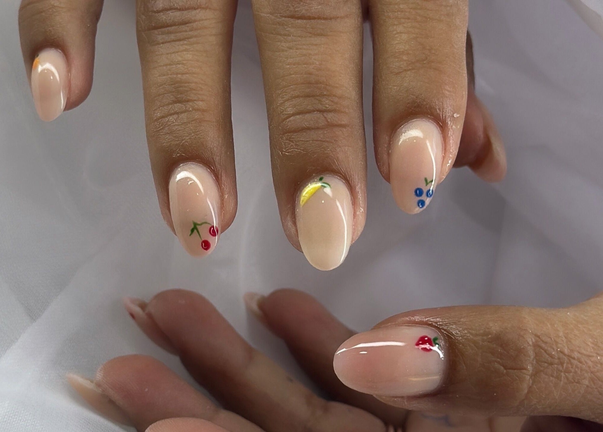 Elegant fruit nail art at Majesty Nails and Spa, Calgary, Alberta, CA, showcasing unique designs.